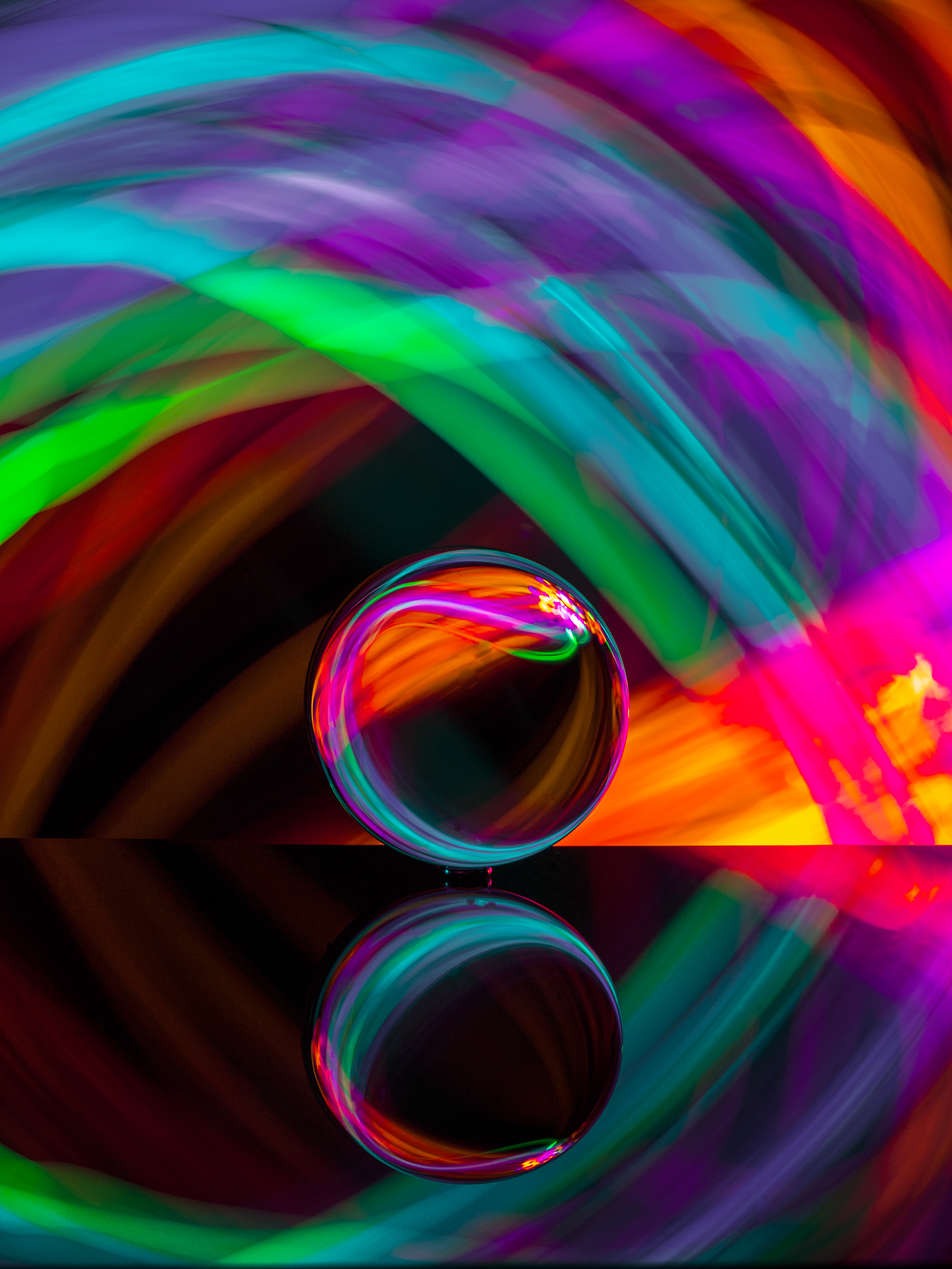 Neon background with a glass orb in the foreground