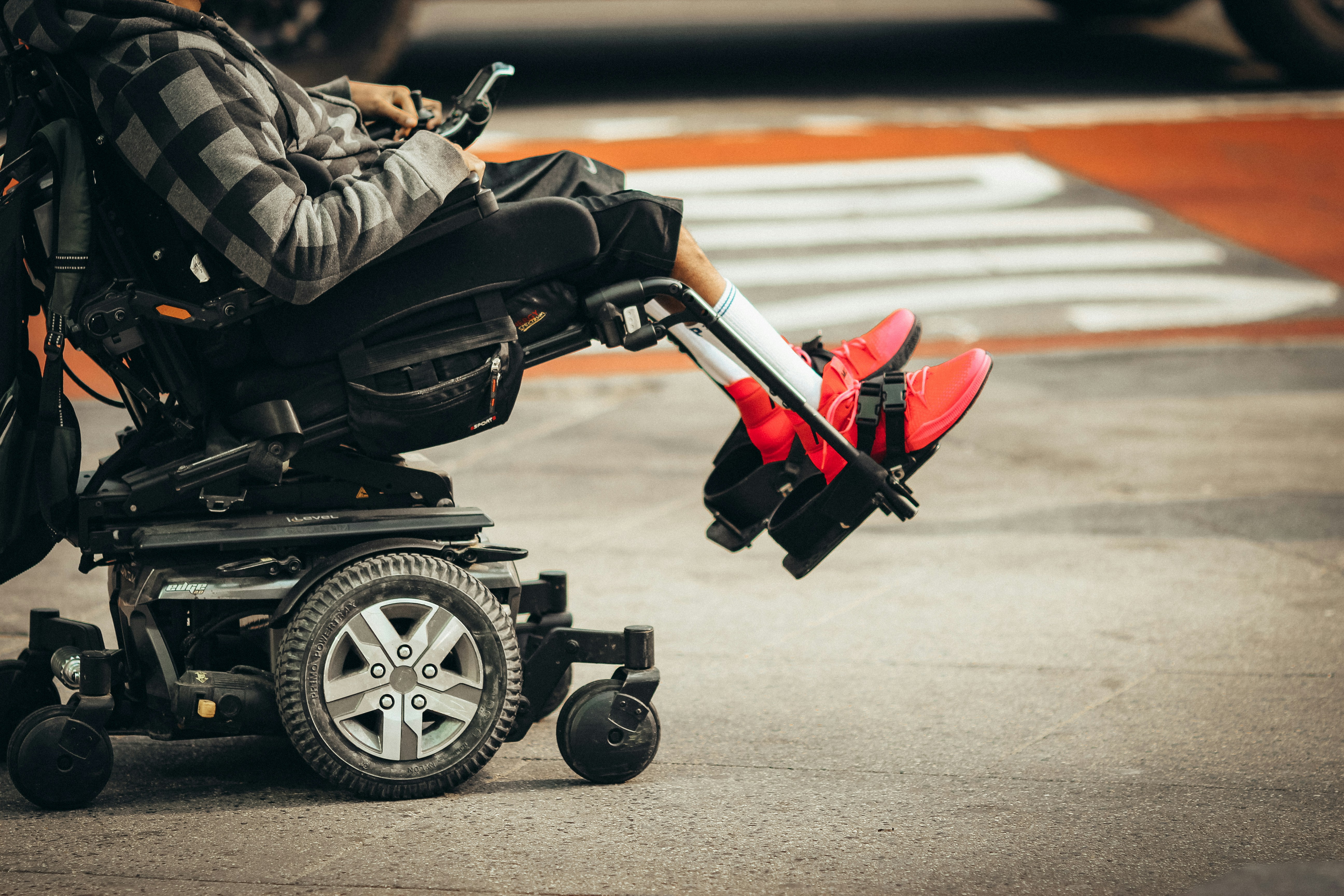 cropped side profile photo of a person in a mobility scooter or wheelchair